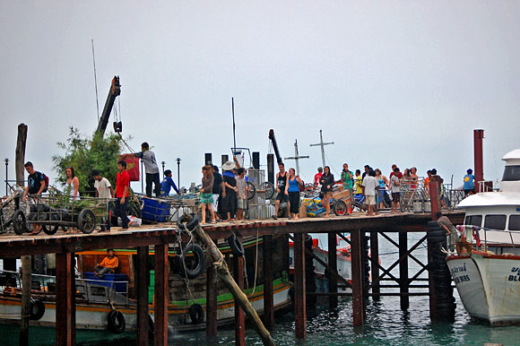 Tourists and commercial deliveries fight for space on the deteriorating pier.
