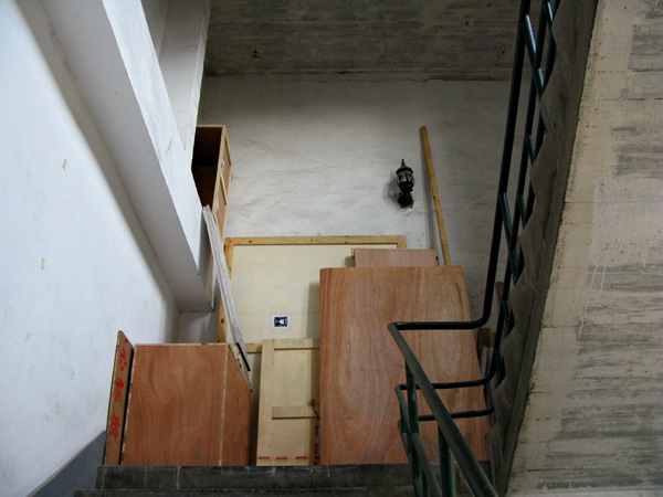 And the stair well with the antique light fixture and stacks of doors.