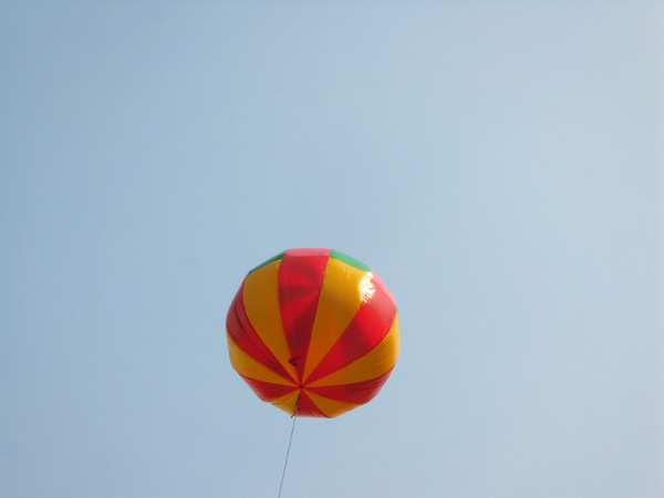 A huge balloon floats above the crowds at today's Dragon Boat Festival