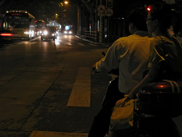 Lady sitting side-saddle at a stop light