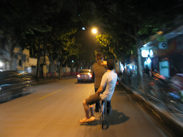 Andy sitting side-saddle riding down the road