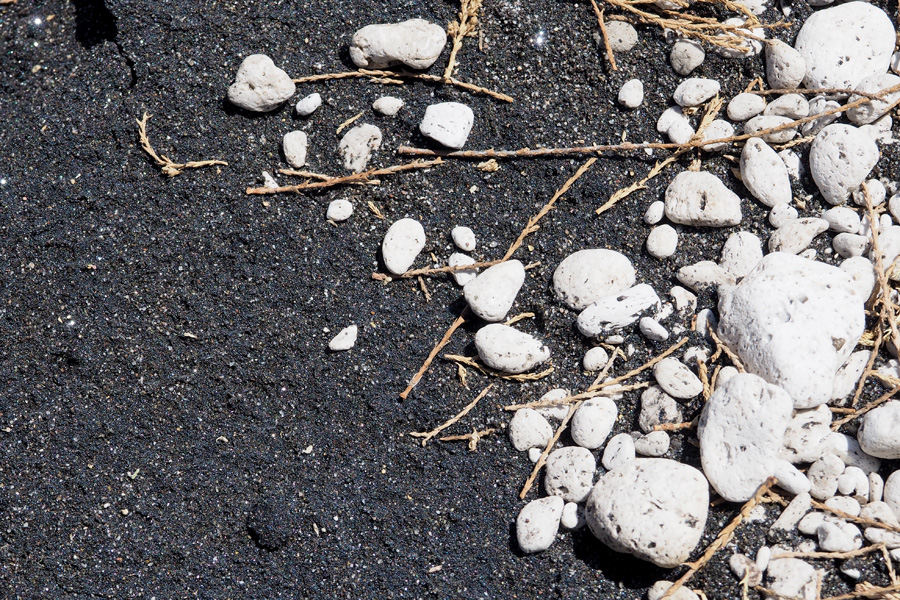 Volcanic black sand and stark white rocks